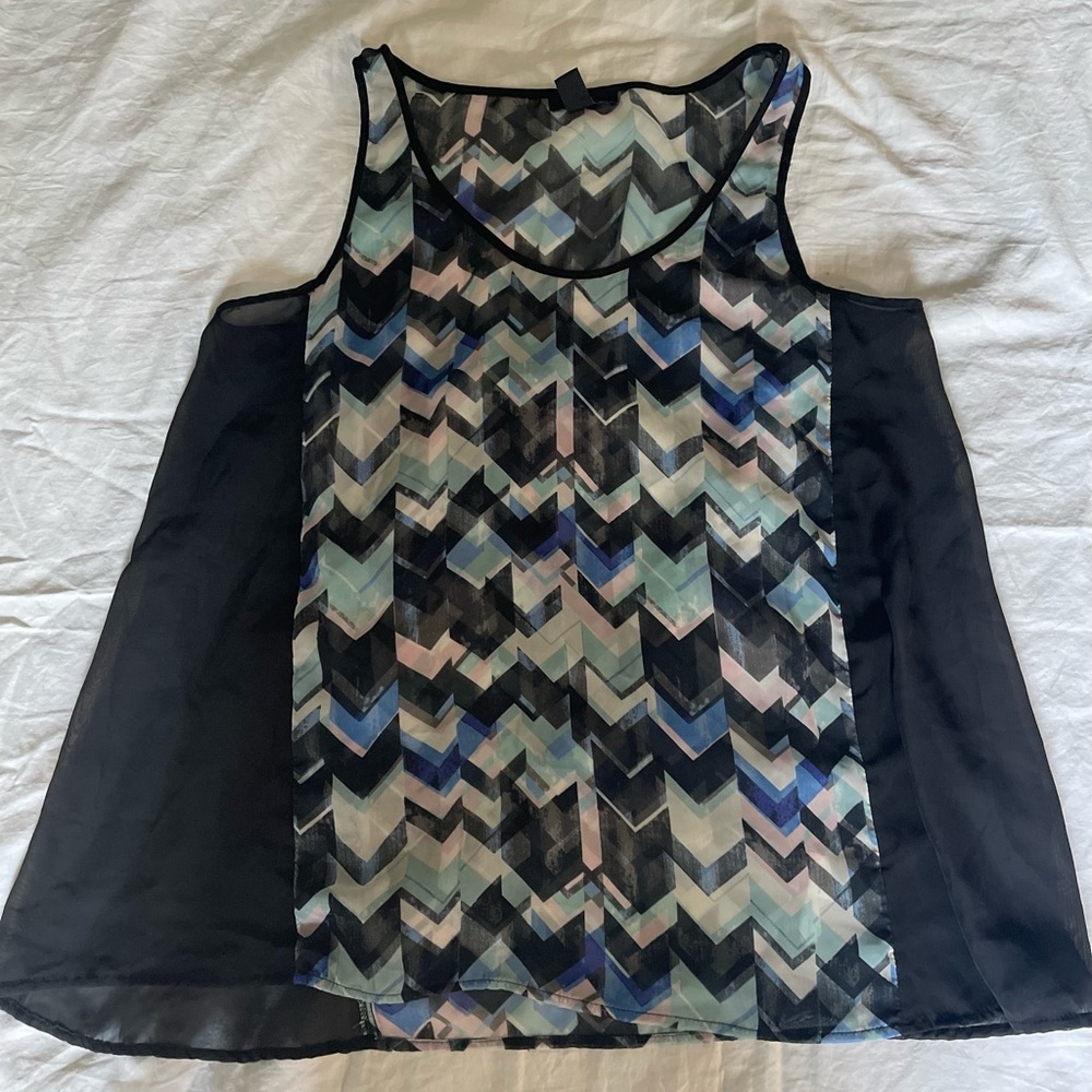 Geometric sleeveless sheer blouse.